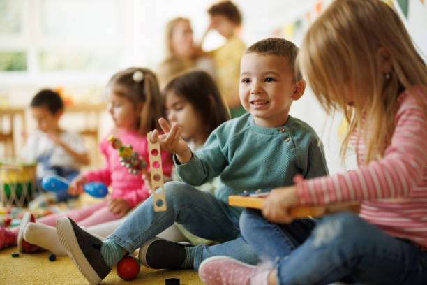 istock Happy kids holding music instruments indoors 2175905659
