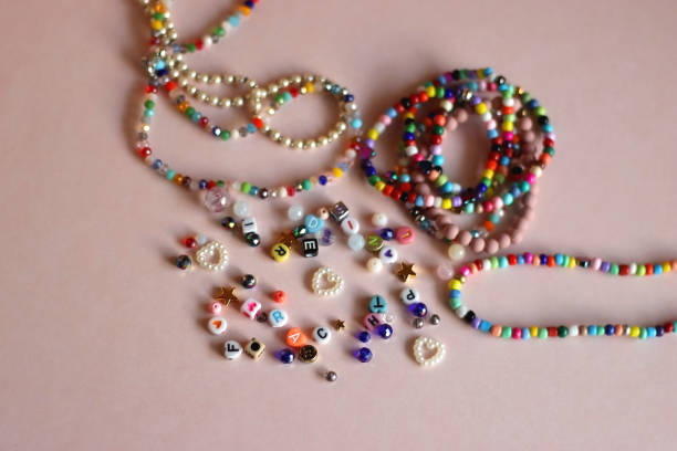 istock Colorful Bracelets, Necklaces And Beads On Pink Background 2175906340