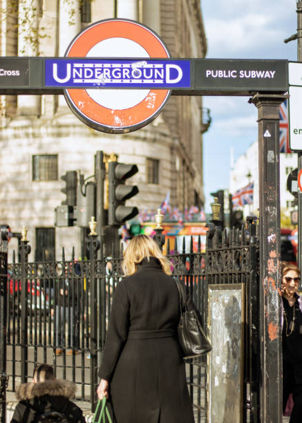 London, England, Apr 25 2023: Trafalgar Square underground entrance during the day with people going down the stairs