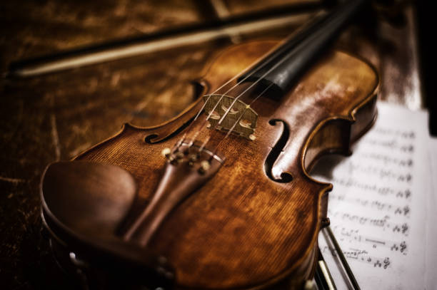 old violin with bow and music sheet