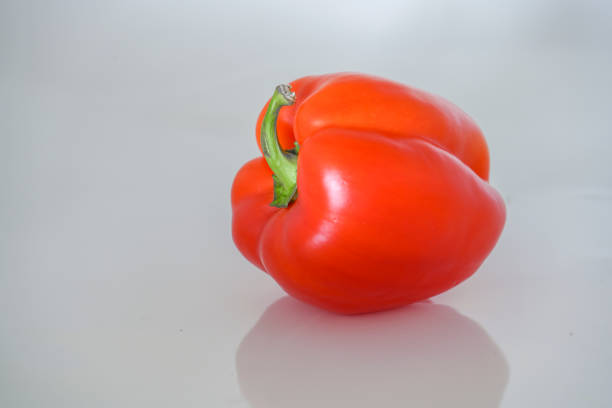 Red pepper on green pastel background. Side view, copy space. healthy food, vegetable, minimalism.