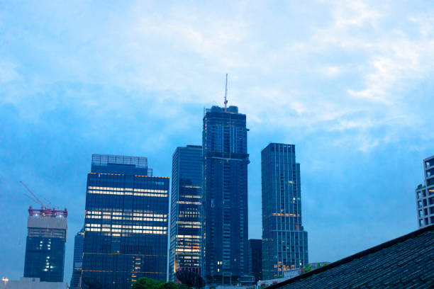 One Bangkok towers skyline in early sunset and evening time. Modern buildings in Lumphini district seen from footbridge and skywalk Benchakitti-Lumphini Park Sky Bridge