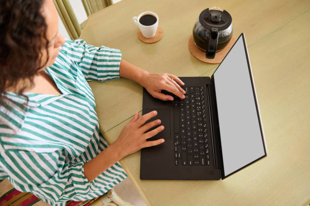 istock Woman working from home with a laptop and coffee 2175927522