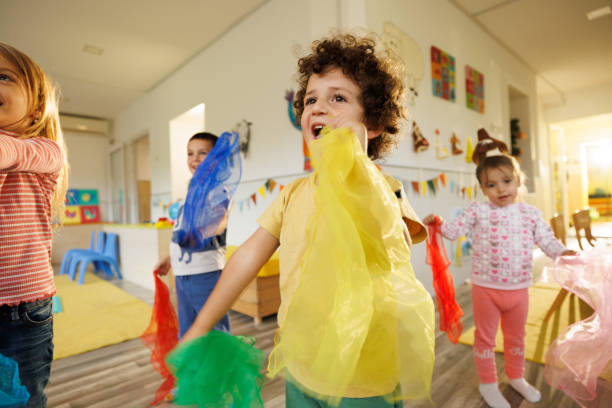 istock Kids holding colorful scarf while dancing indoors 2175937247