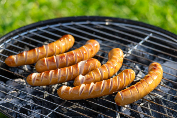freshly grilled sausages on charcoal grill in the garden