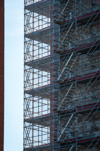 istock Scaffold sheeting net wrapped apartments building during insulation in england uk 2175950054