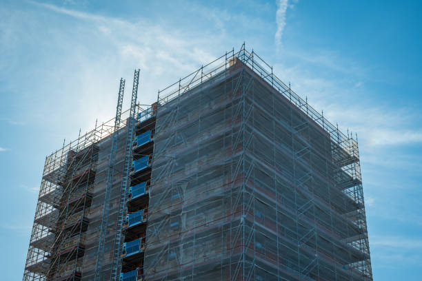 istock Scaffold sheeting net wrapped apartments building during insulation in england uk 2175950055