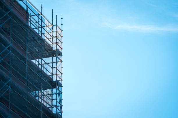 istock Scaffold sheeting net wrapped apartments building during insulation in england uk 2175950067