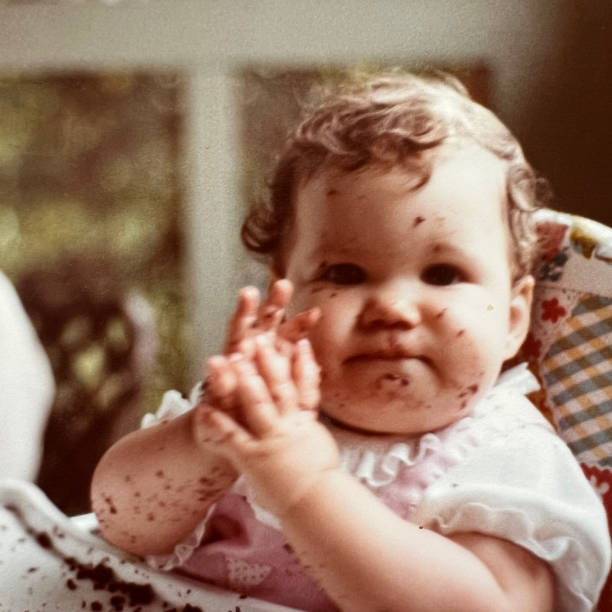 Baby in High Chair with Chocolate Cake
