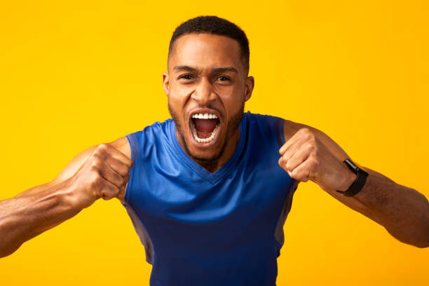 istock Emotional black guy celebrating triumph gesturing at studio 2175955442