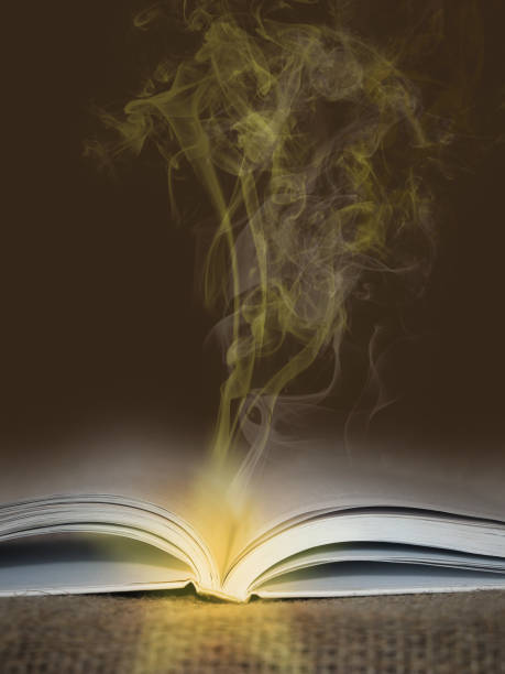 istock Open book with glowing yellow smoke going from it - magic and mystic concept 2175962430