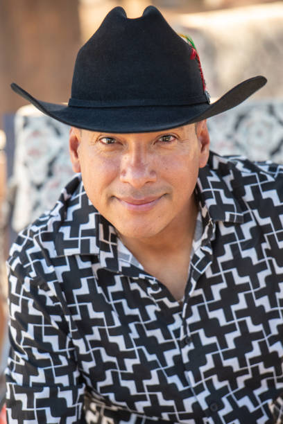 istock Smiling Hispanic cowboy posing wearing a cowboy hat looking at the camera 2175962715