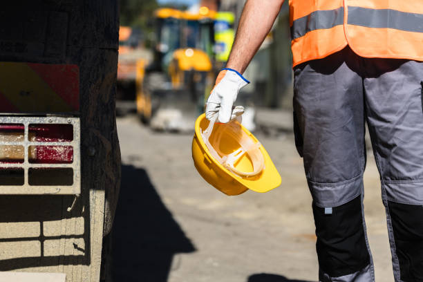 istock Construction worker holding a safety helmet on a busy construction site during daylight hours 2175964073