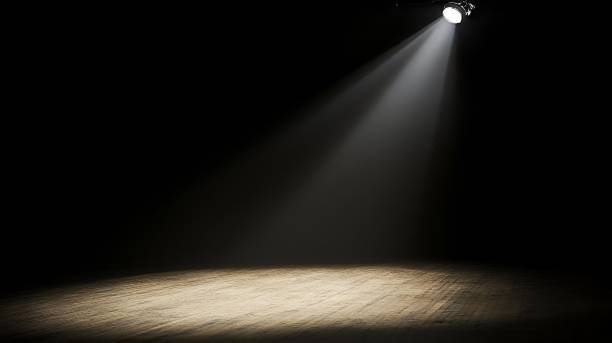 istock Spotlight on empty wooden stage in dark theater. 2175964541