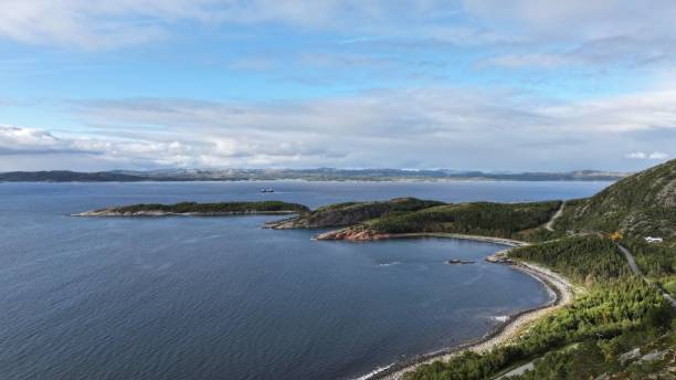istock Scenic coastal bay with clear blue skies and lush greenery 2175964861