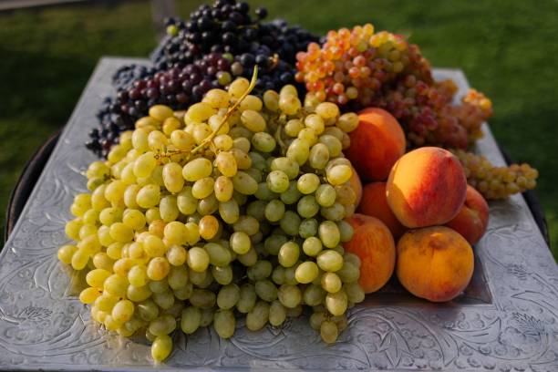 istock Fresh grapes and peaches on a decorative tray 2175965206
