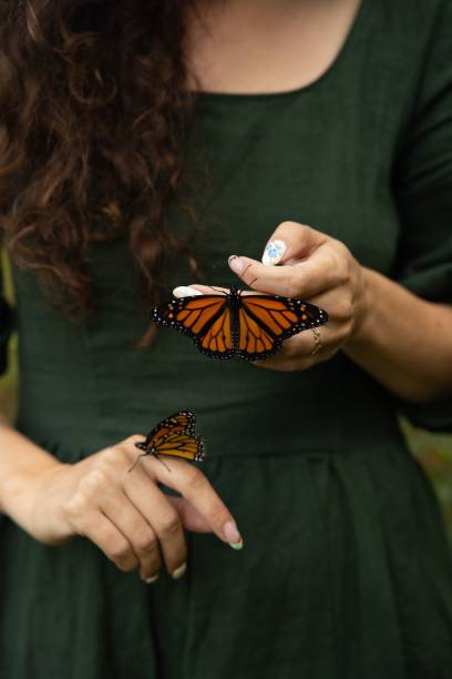istock Woman holding monarch butterflies 2175965570