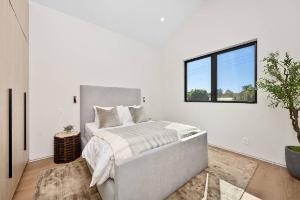 istock Modern bedroom with cozy bed and wooden wardrobe 2175965663