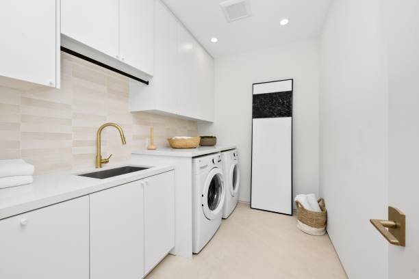 istock Modern laundry room with white cabinets and appliances. 2175965682