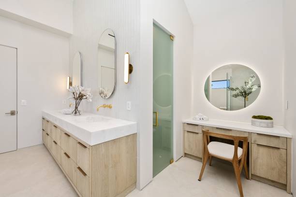 istock Modern bathroom with light wood cabinets and vanity area 2175965699