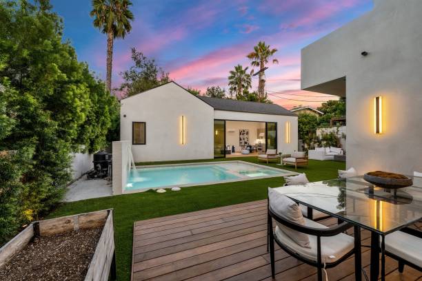 istock Modern backyard with pool and patio furniture at sunset. 2175965725