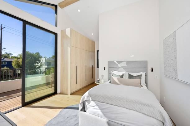istock Modern bedroom with large windows and minimalist decor. 2175965731