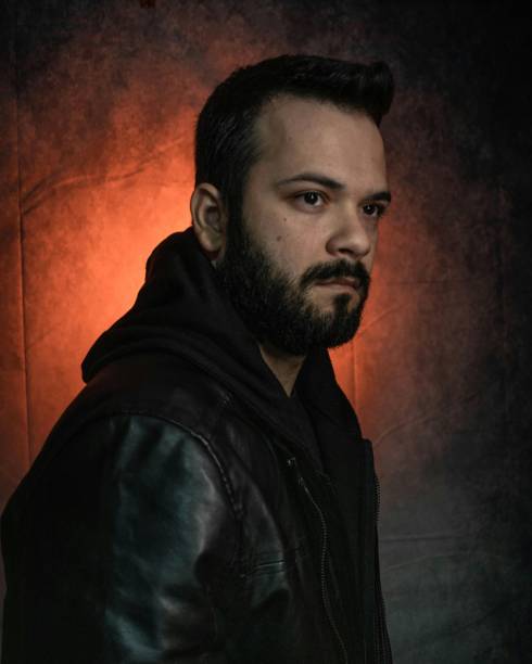 istock Brazilian Man in black hooded jacket with soft studio lighting highlighting the jacket's texture 2175965883