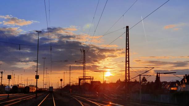 istock Sunset over railway station with vibrant sky. 2175966473