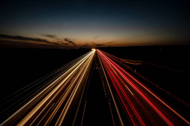 istock Long-exposure car light trails on a highway at sunset 2175967331