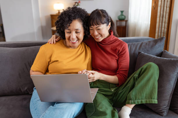 istock Lesbian couple relaxing at using a laptop at home 2175967904