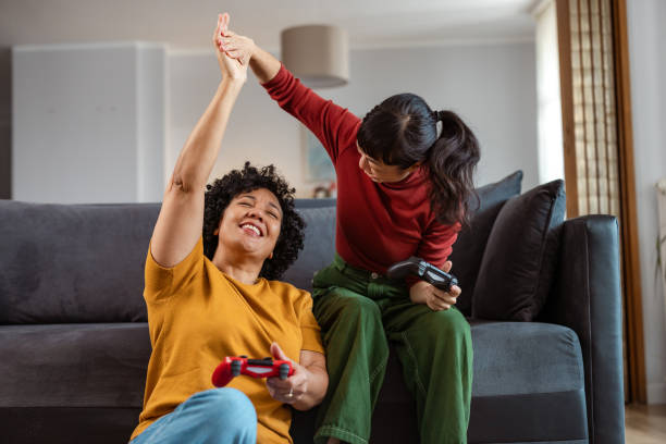 istock Two women feeling happy while playing video games 2175968070