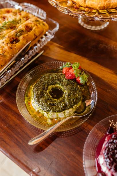 istock Herb-crusted cheese with strawberries on a glass plate. 2175968425