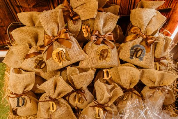 istock Burlap gift bags with decorative elements on hay bale. 2175968456