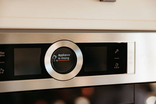 istock Modern kitchen appliance display showing 'Appliance is rinsing'. 2175969057