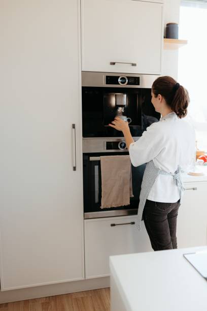 istock Woman making coffee in modern kitchen 2175969060