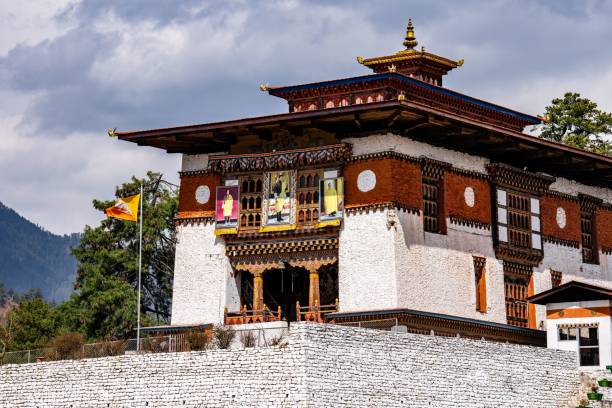istock Traditional Bhutanese building with flag and mountain backdrop. 2175969190