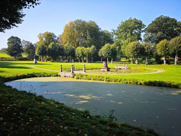 istock Scenic park view with pond and statues on a sunny day 2175969887
