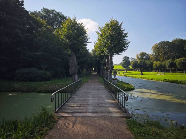 istock Serene wooden bridge over a tranquil canal on a sunny day. 2175969895
