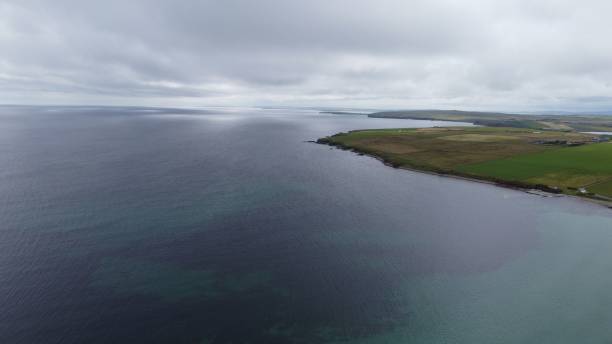 istock Aerial view of coastal landscape with cloudy sky and green fields. 2175970708