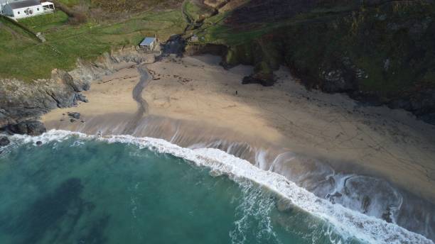 istock Aerial view of a secluded beach with turquoise waters and rocky cliffs. 2175970721