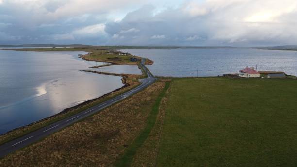 istock Scenic coastal road leading to a small settlement 2175970745
