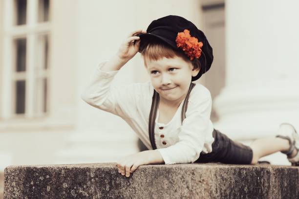 Portrait of a funny boy in a vintage cap on a white background.