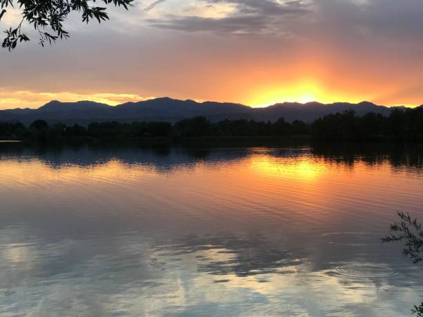 istock Serene sunset over a lake with mountains 2175971813