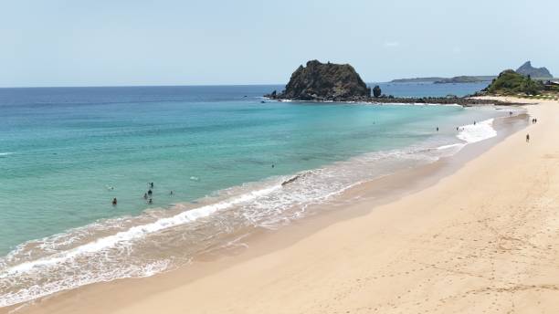 istock Serene beach scene with turquoise waters and rocky formations 2175971885