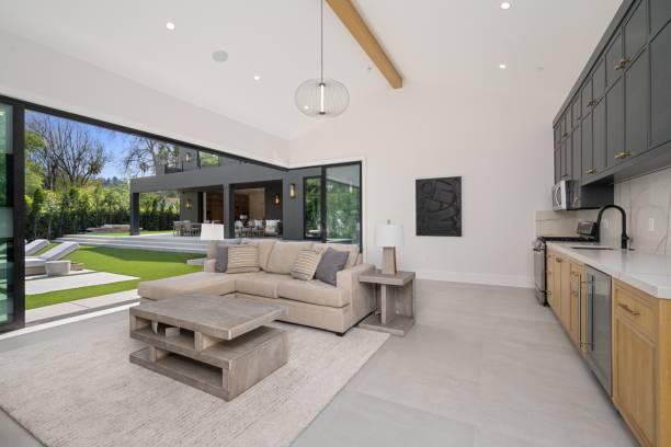 istock Modern open-concept living room and kitchen with backyard view. 2175972339