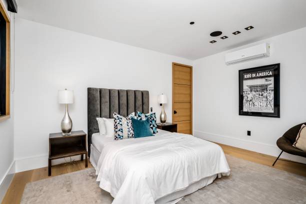 istock Modern bedroom with grey upholstered bed and stylish decor. 2175972405