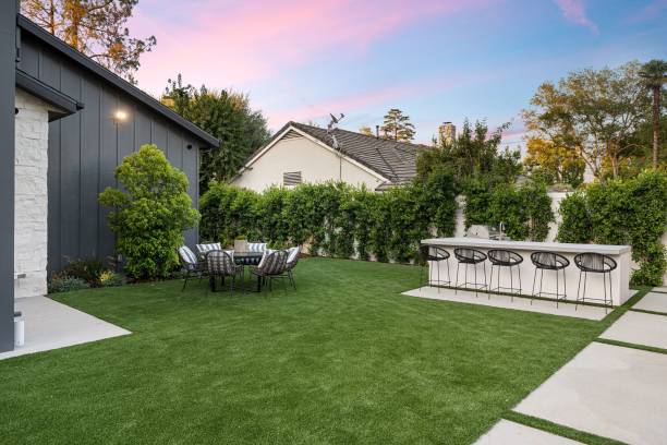 istock Modern backyard with dining set and bar area at sunset 2175972408