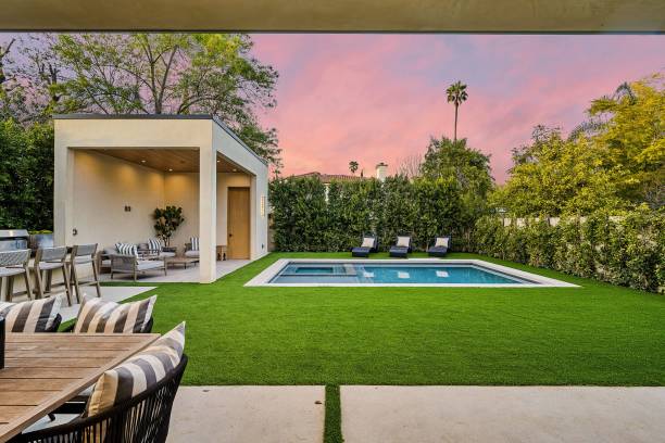 istock Modern backyard with pool and lounge area at sunset 2175972518