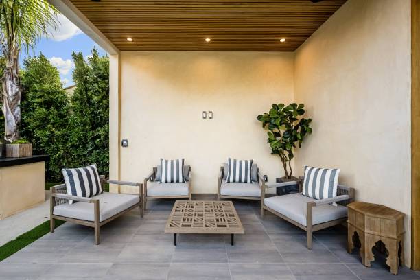 istock Modern outdoor patio with cushioned chairs and greenery 2175972537