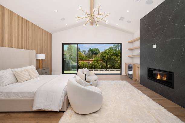 istock Modern bedroom with fireplace and large window. 2175972605